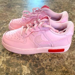 Nike AF1 foam pink shoes.